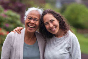 mixed race mother and daughter walk and talk together outside
